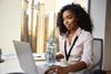 Woman sat at work desk with a bottle of water