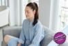 Lady practising breathing on her sofa