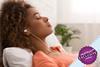 Woman relaxing on her sofa with her eyes closed