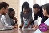 Team of diverse people in discussion round a table