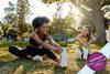 Two women doing stretches in a park