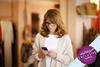 Woman standing in a store making a call on her mobile