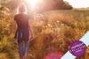 Woman walking in a sunny field