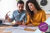 Couple sat at table looking over paperwork