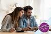 Couple sat at a table looking at a laptop making notes