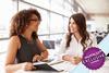 Two women chatting in office