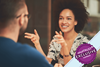 Woman sat talking and smiling at a man