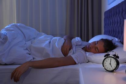 Person asleep in bed looking peaceful