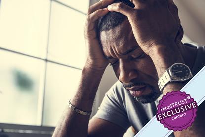 Man holding his head in his hands looking distressed