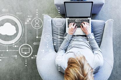 Aerial view of man sitting on a sofa working on a laptop