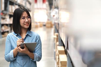 Image of asian lady stock taking