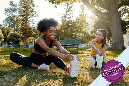 Two women doing stretches in a park