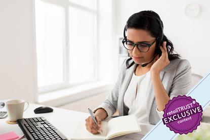 Woman at desk talking into a headset