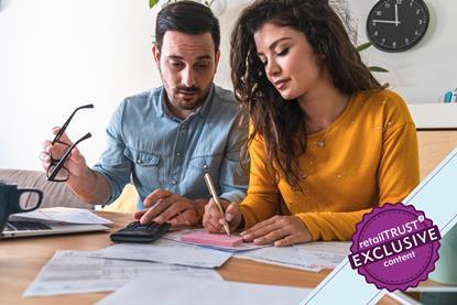 Couple sat at table looking over paperwork