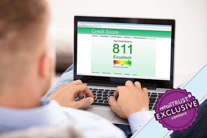 Man checking credit score on laptop badge