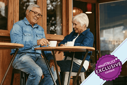 Older couple sat at a coffee shop laughing