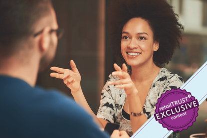 Woman sat talking and smiling at a man