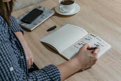 Individual completing a puzzle book