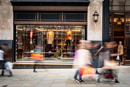 Shop front image with blurred people walking past