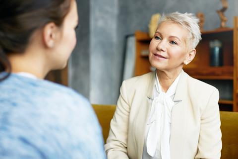 Two women talking face to face